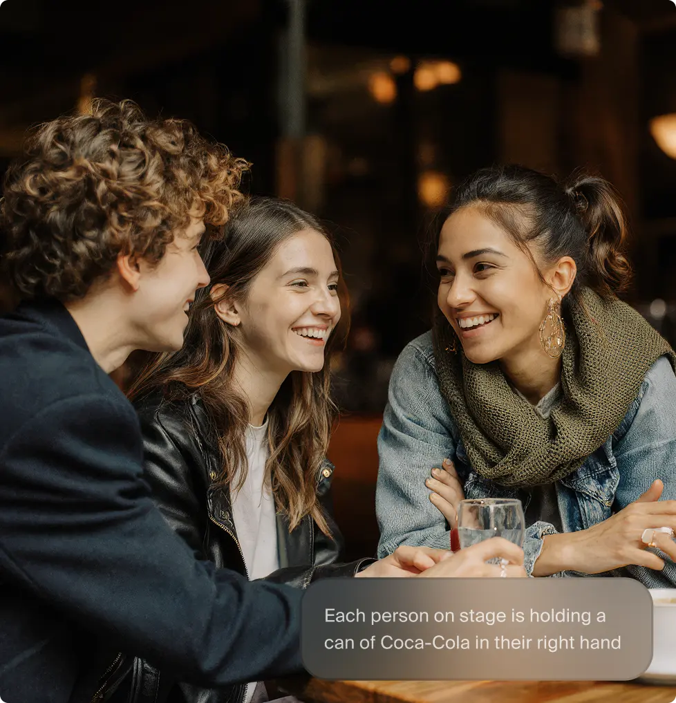 Three people at a cafe table with a prompt to add soda cans to their hands