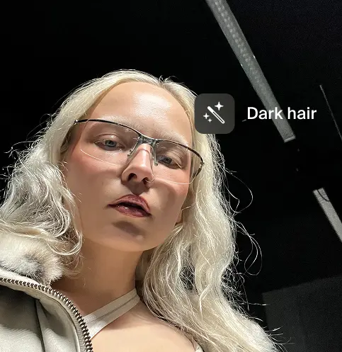 Portrait of a person with blonde hair and a prompt to change the hair to dark hair